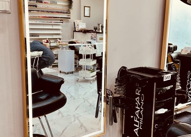 Modern interior of Golden Lotus Beauty Salon in Sharjah, AE, showcasing salon station and mirror reflections.
