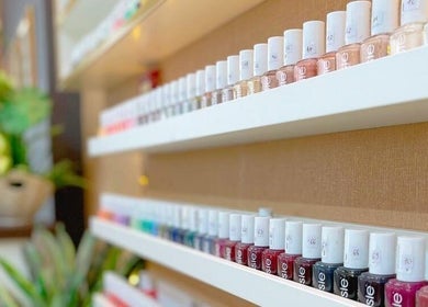 Vibrant nail polish display at Golden Lotus Beauty Salon, Sharjah, AE, showcasing various colors.