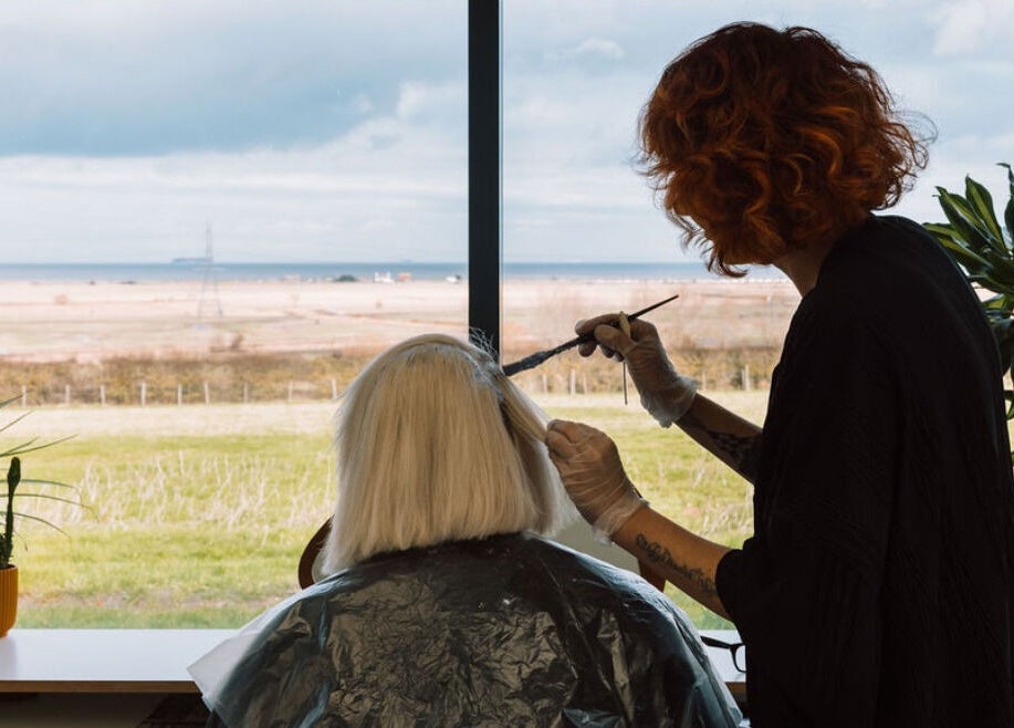 Stylist coloring hair at Hayley Edwards, Creative Space Kent with ocean view, Faversham, England, GB.