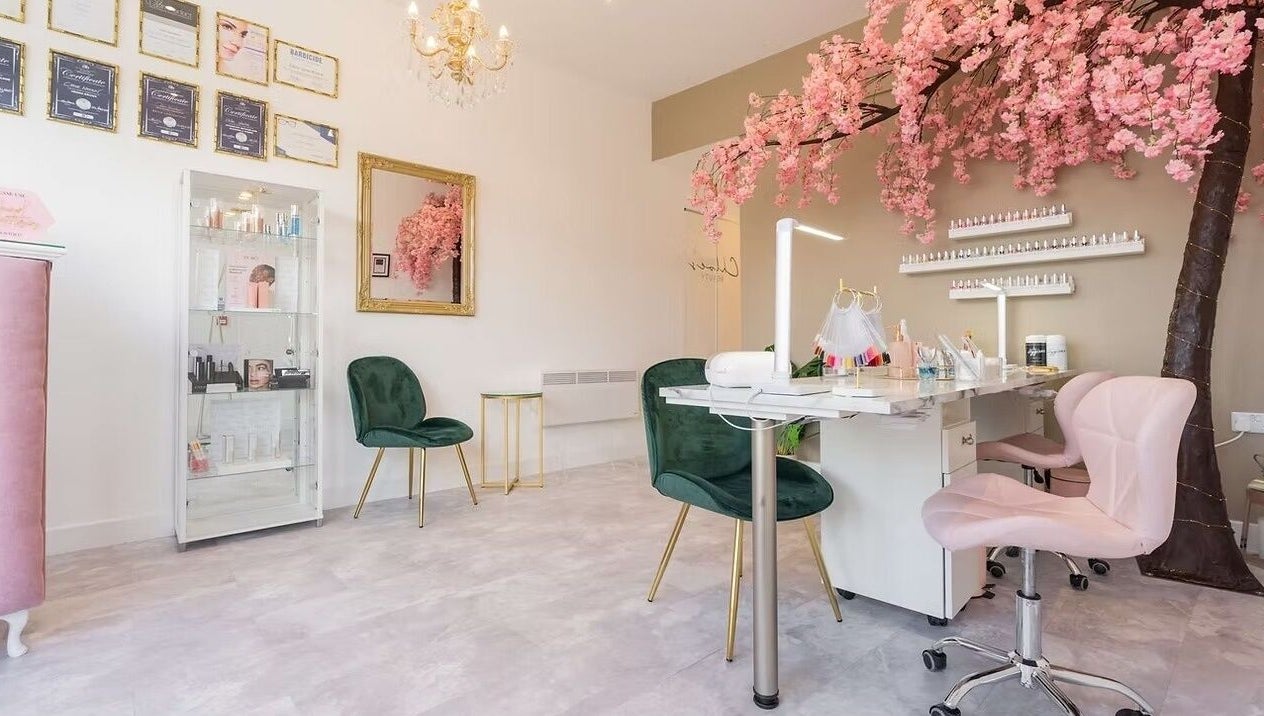 Chloe's Beauty salon in Carlisle, England, GB featuring elegant decor with pink blossoms and chic seating.