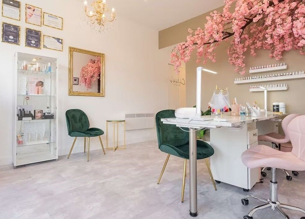 Chloe's Beauty salon in Carlisle, England, GB featuring elegant decor with pink blossoms and chic seating.