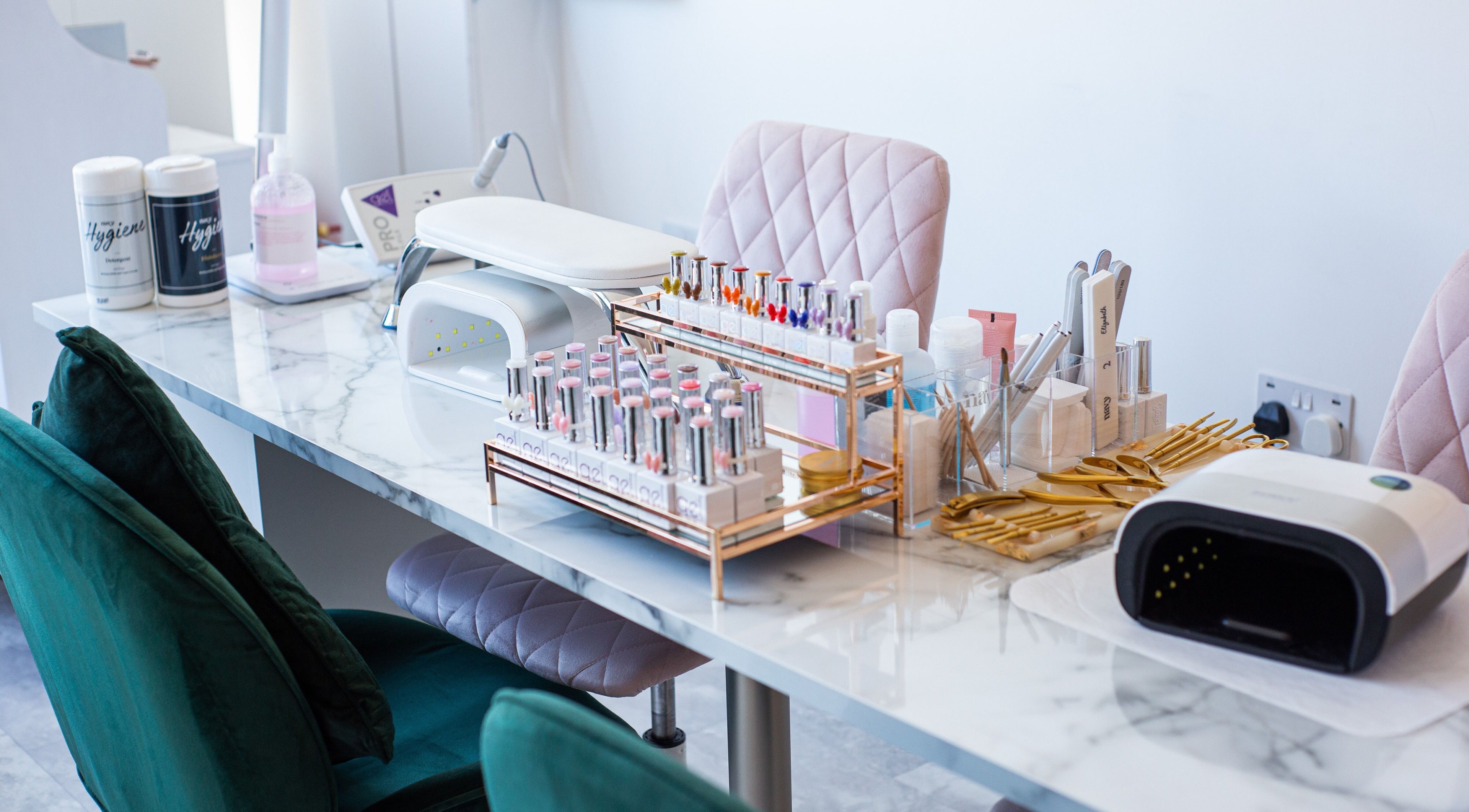 Manicure setup at Chloe's Beauty, Carlisle, England, GB with tools and polishes on marble desk.