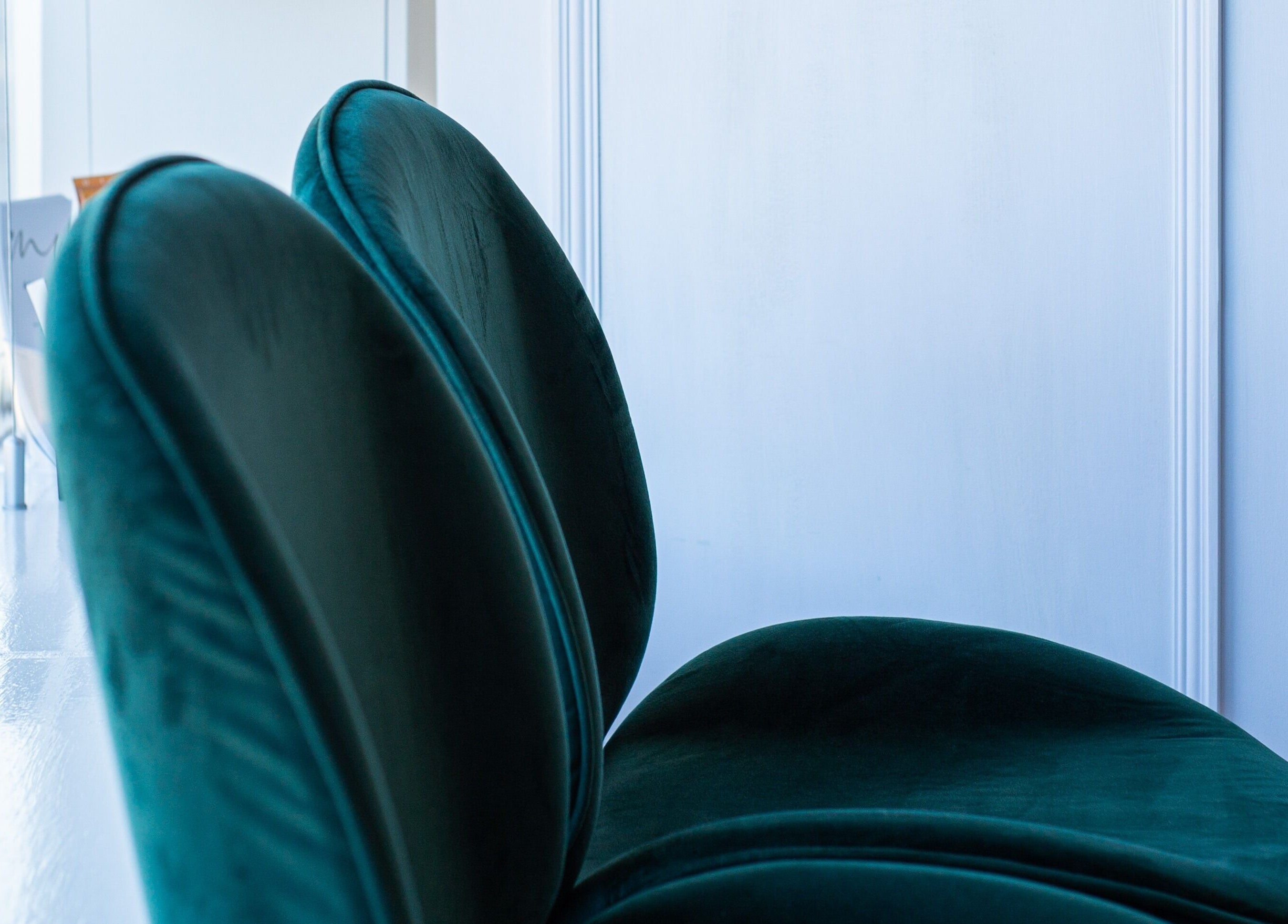 Luxurious green velvet chairs by window at Chloe's Beauty, Carlisle, England, GB.