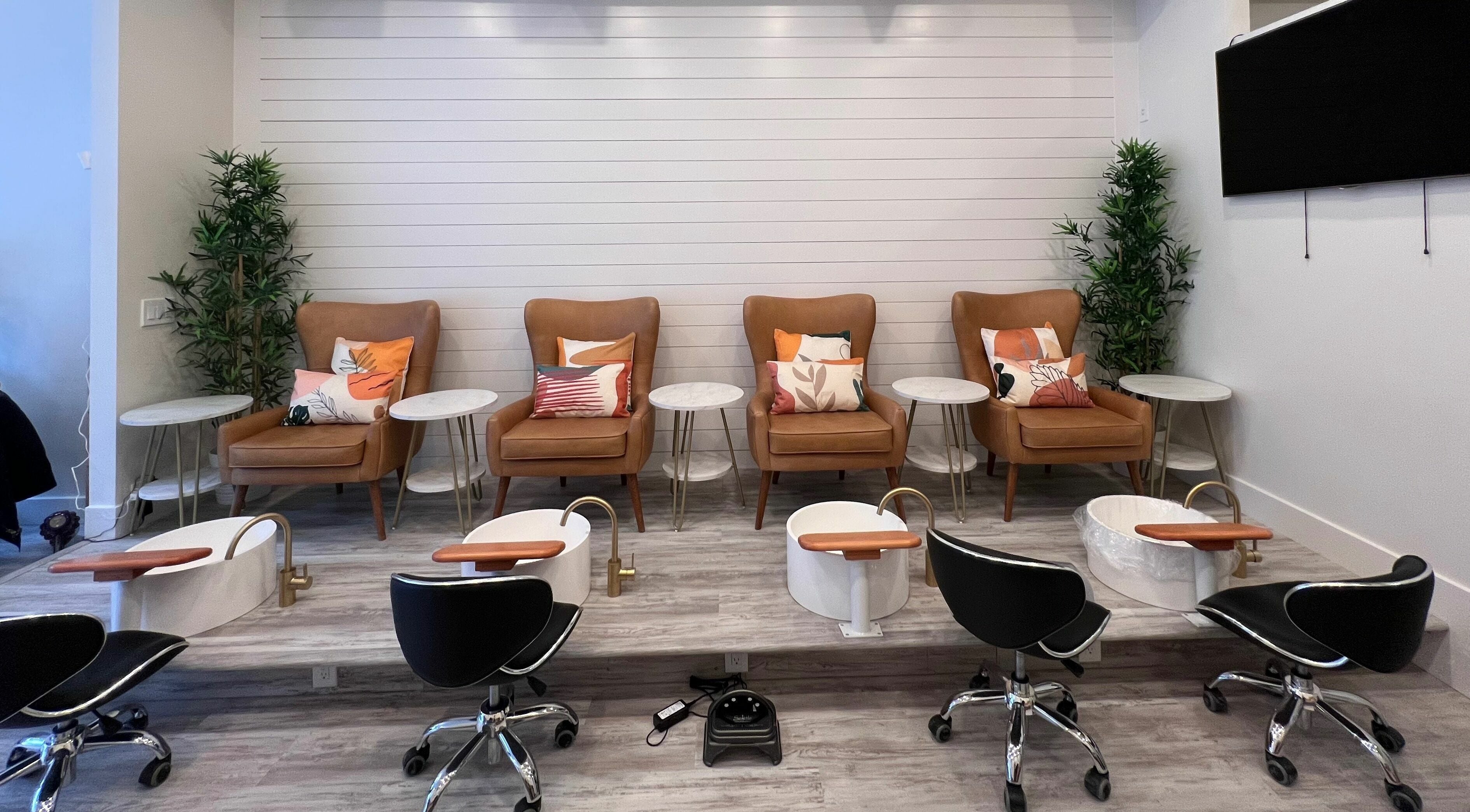 Elegant pedicure seating area at Roosevelt Nails Bar in Seattle, Washington, US with modern chairs and sinks.