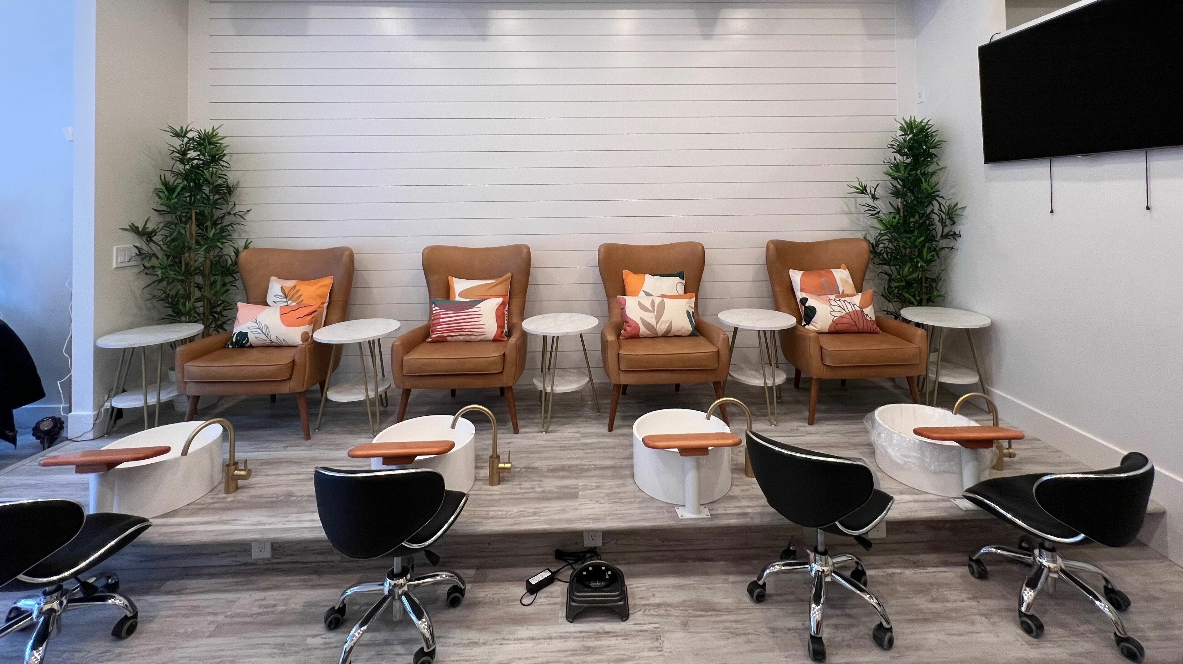 Elegant pedicure seating area at Roosevelt Nails Bar in Seattle, Washington, US with modern chairs and sinks.