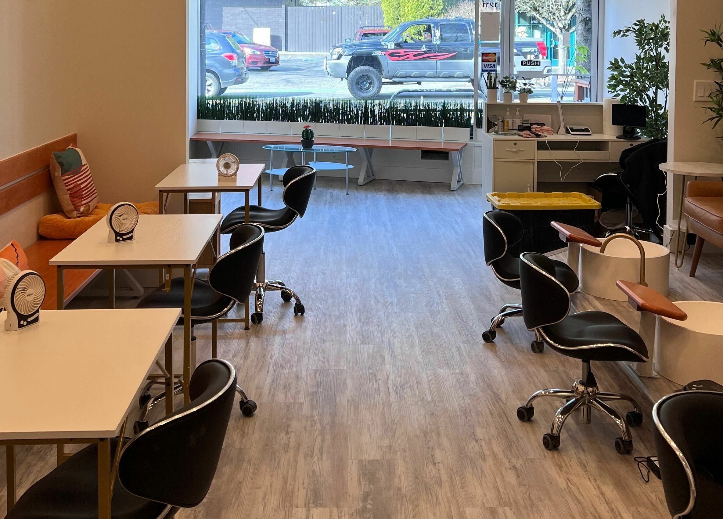 Modern interior of Roosevelt Nails Bar, Seattle, Washington, US with sleek chairs and cozy seating.