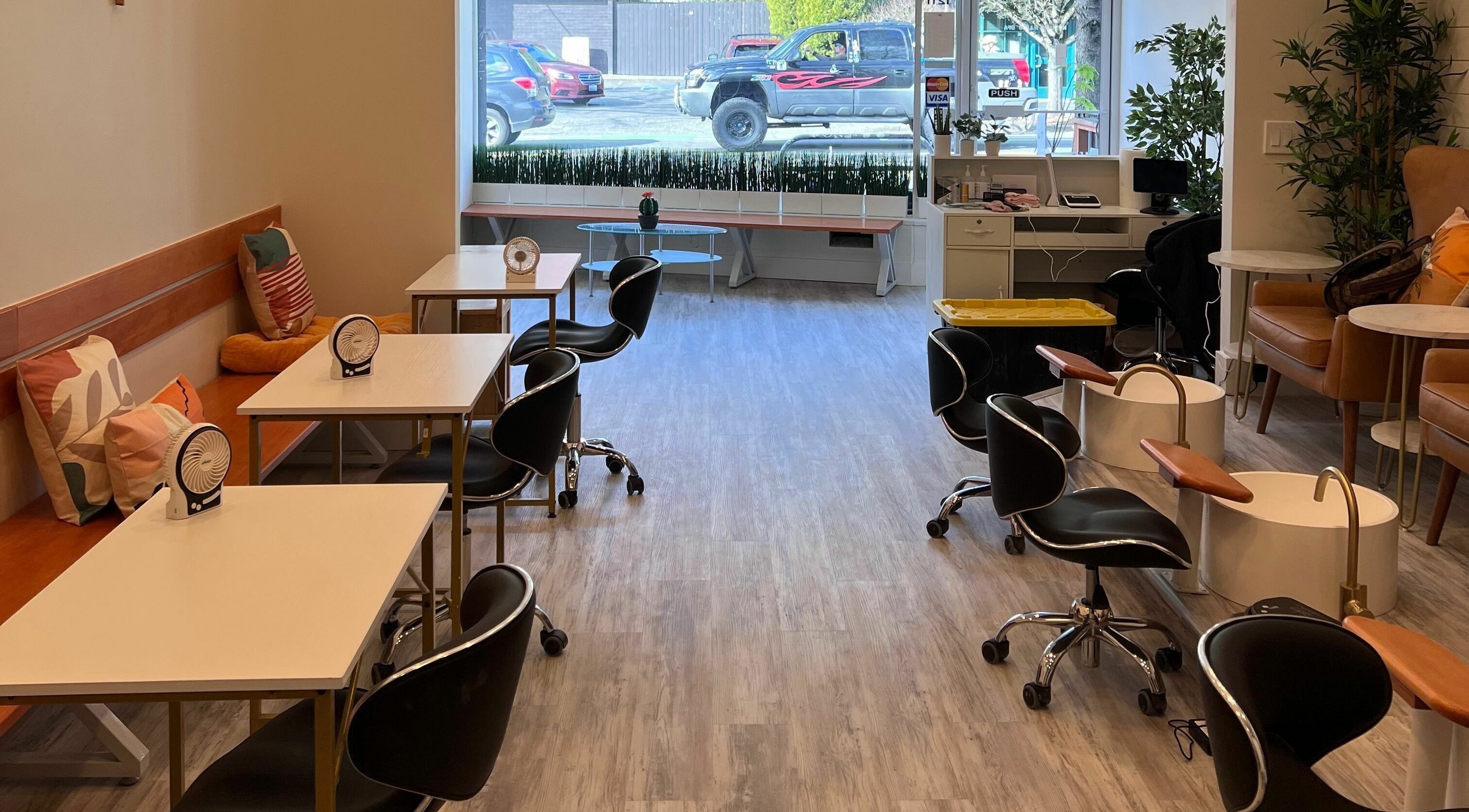 Modern interior of Roosevelt Nails Bar, Seattle, Washington, US with sleek chairs and cozy seating.