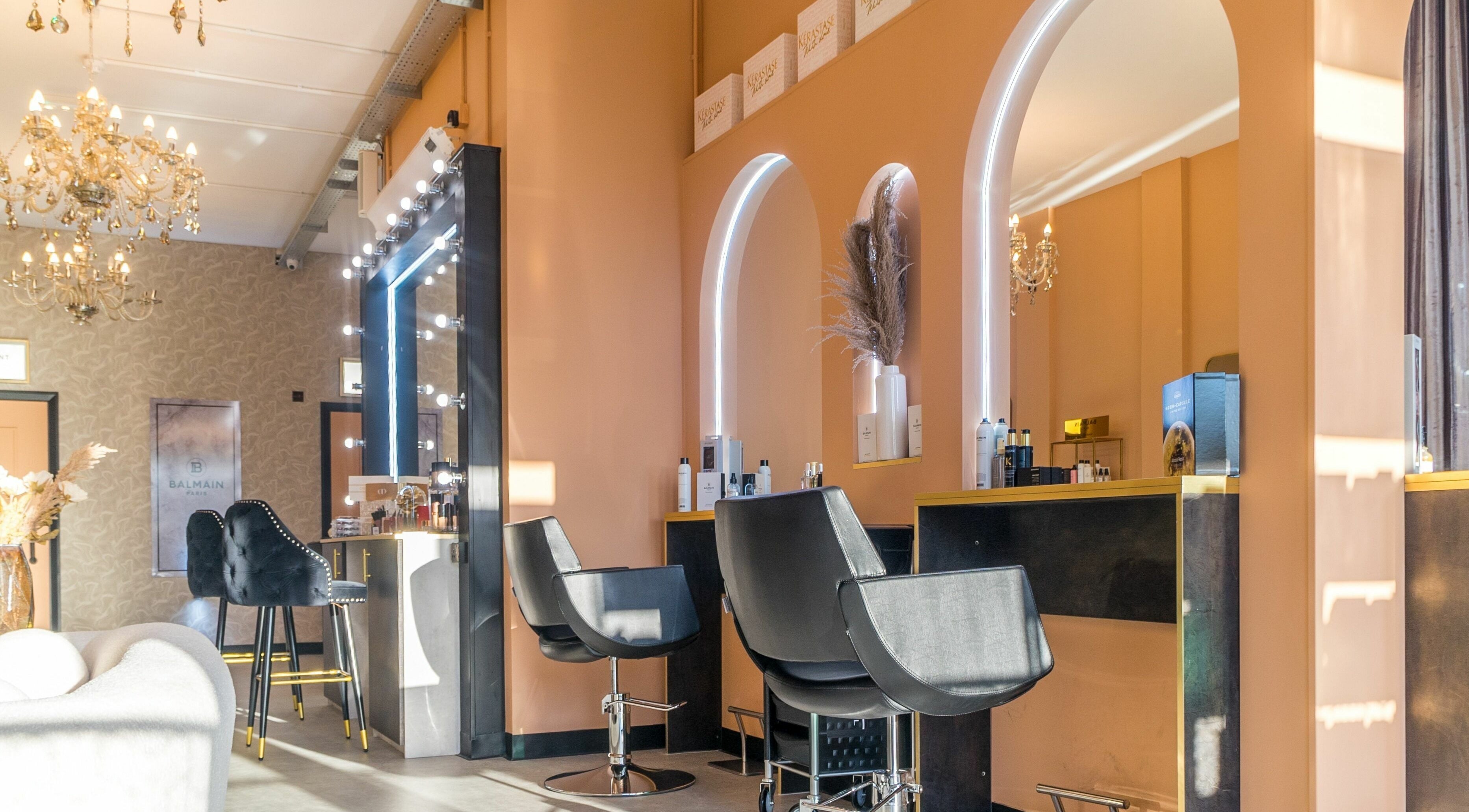 Elegant interior of Marina Salon by FKZ Hair and Beauty, Manchester, England, GB with stylish chairs and mirrors.