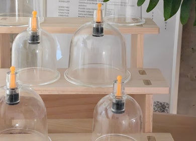 Glass cupping jars at Indulge Pamper Relax, London, England, GB, ready for wellness therapy.