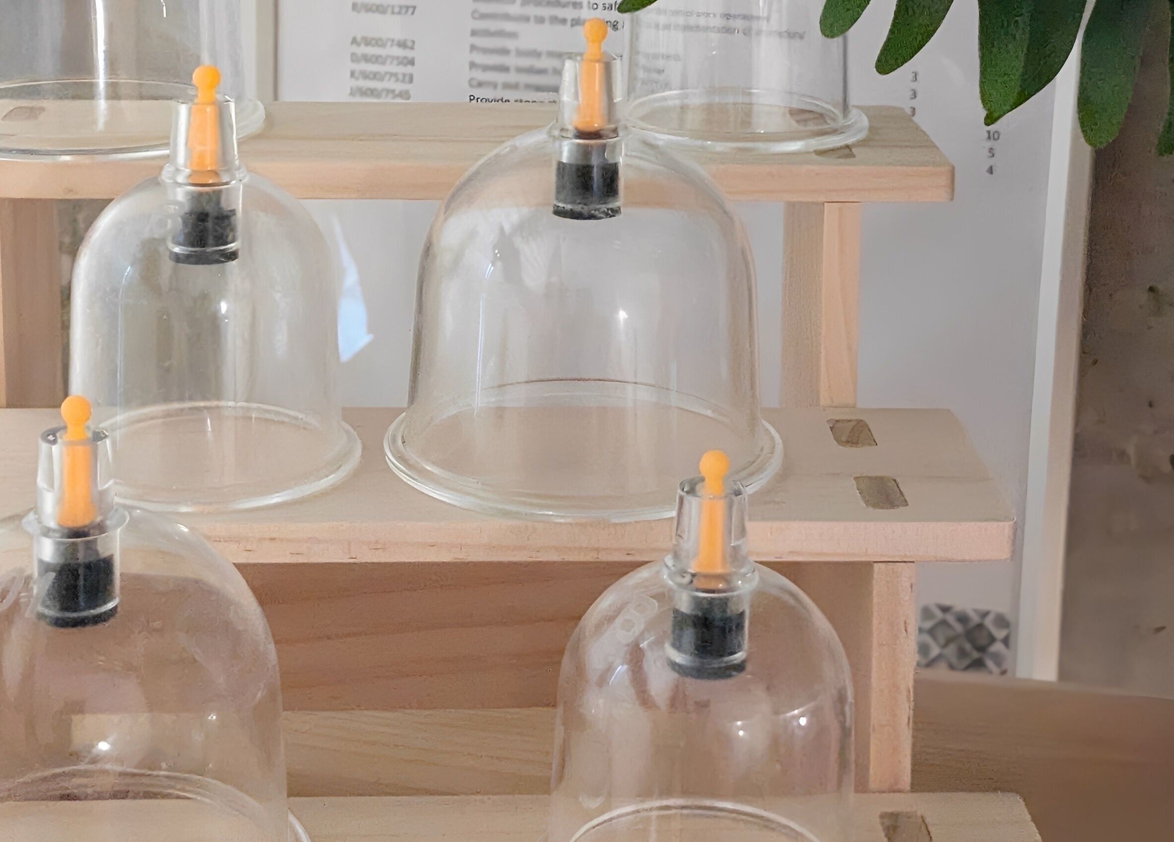 Glass cups on a wooden shelf at Indulge Pamper Relax-The Pamper room, London, England, GB.