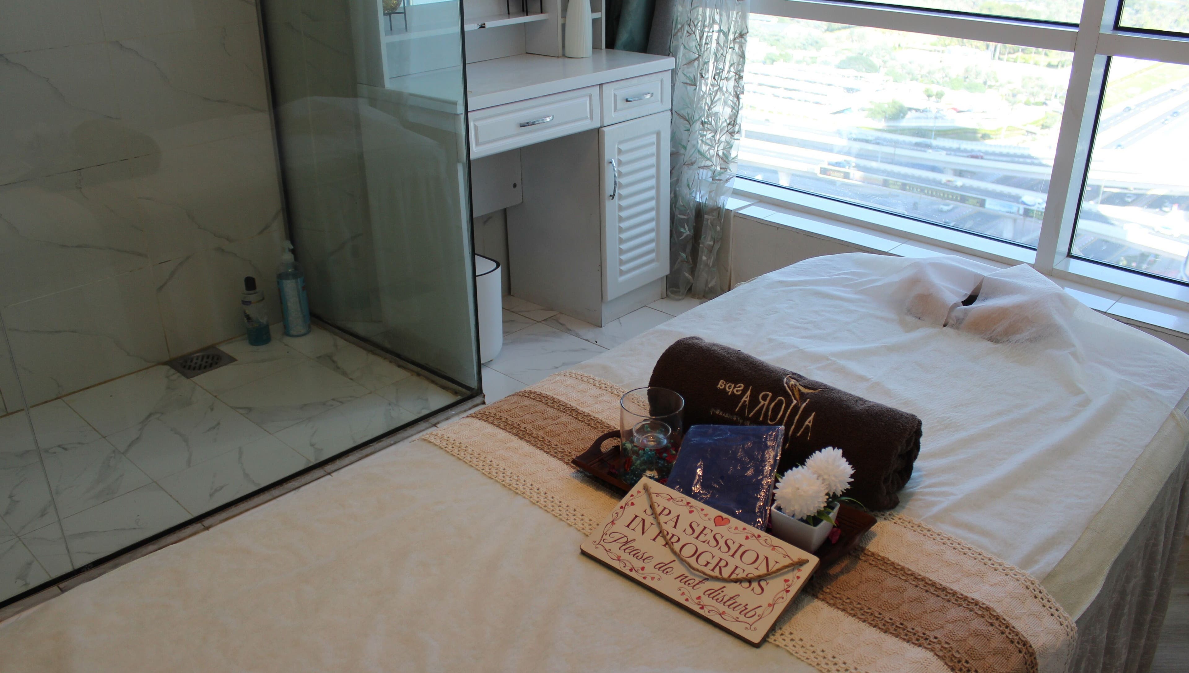 Massage bed at Allora Spa and Massage Centre Dubai, serene setup with a city view in Dubai, Dubai, AE.