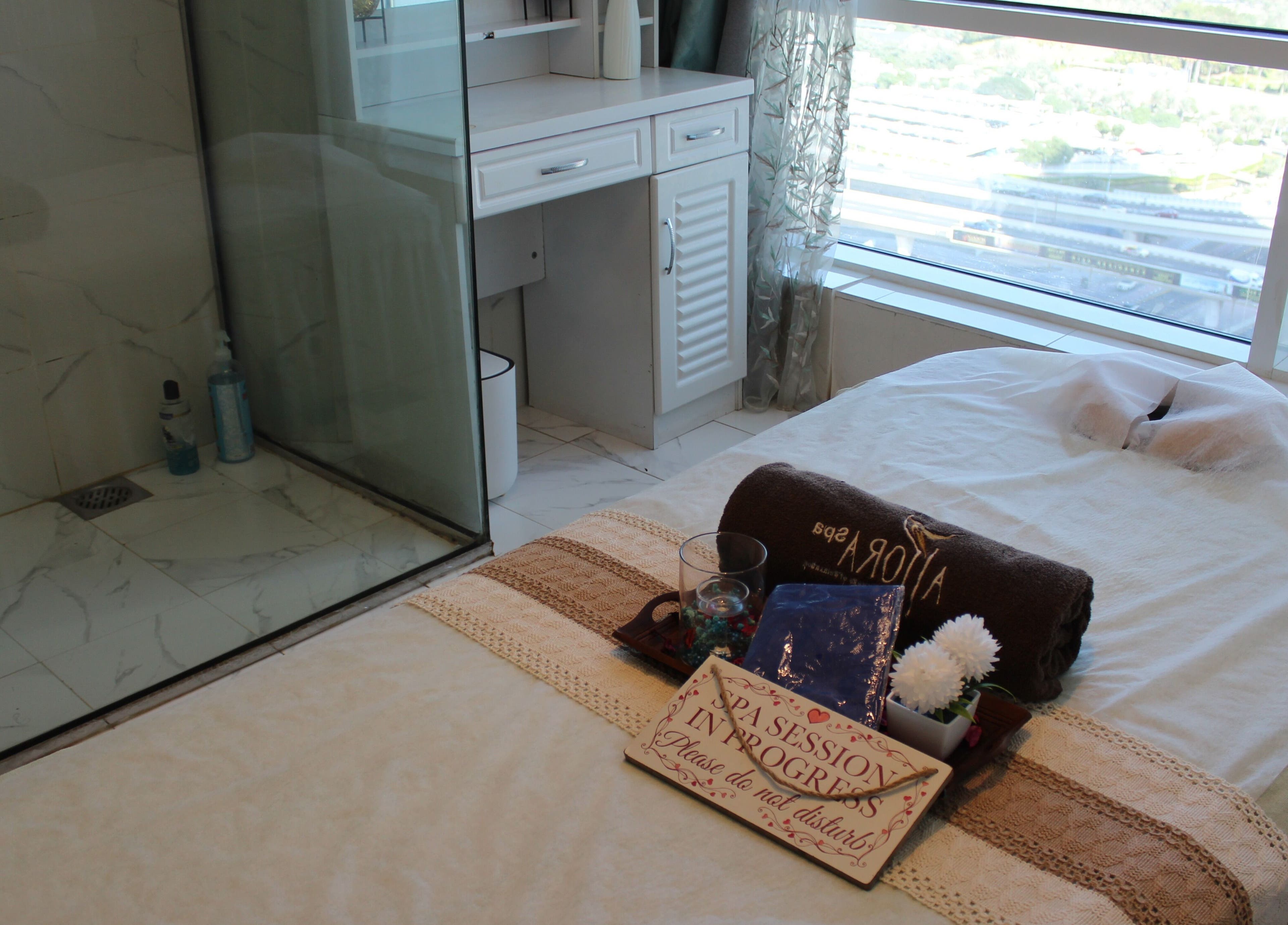 Massage bed at Allora Spa and Massage Centre Dubai, serene setup with a city view in Dubai, Dubai, AE.