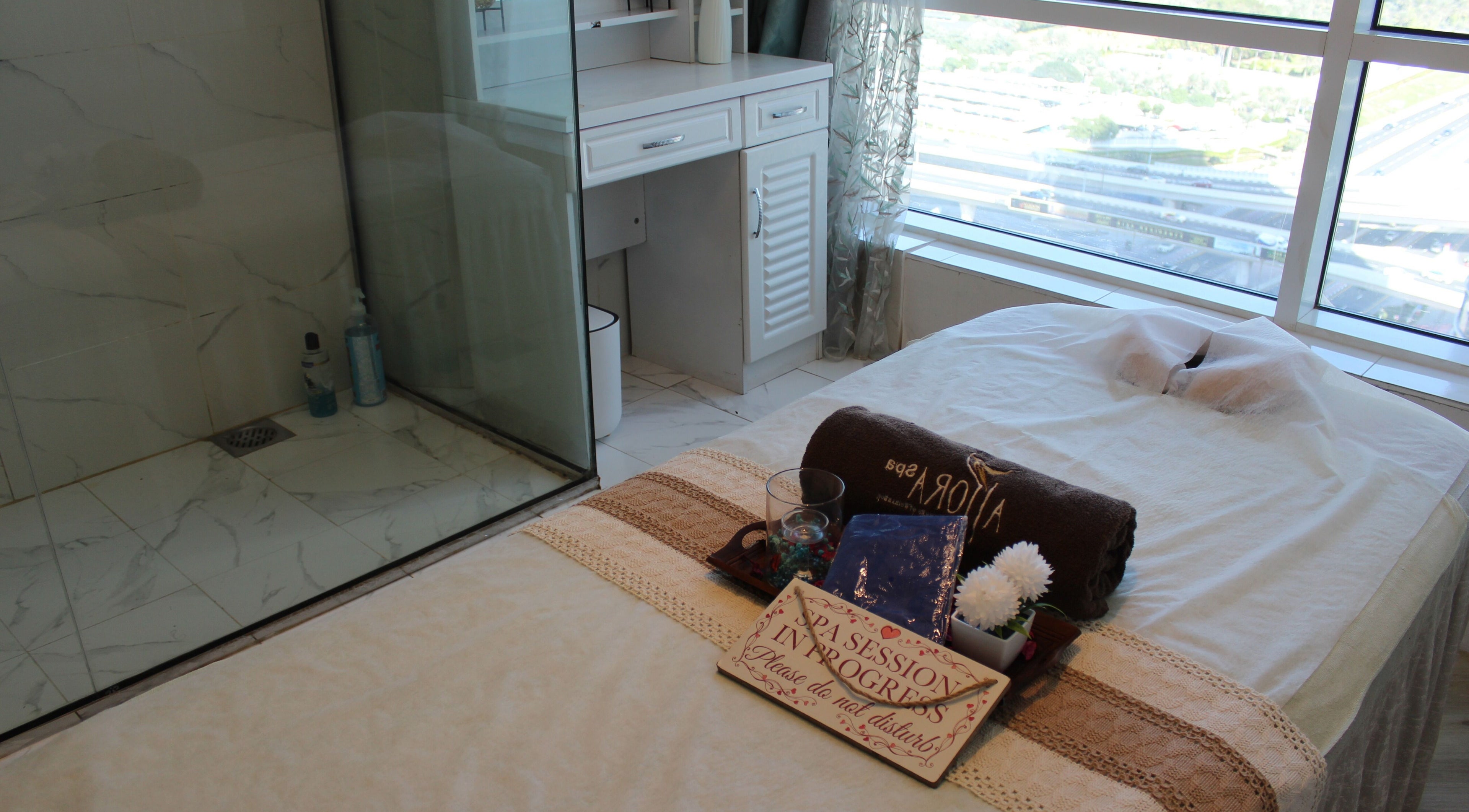 Massage bed at Allora Spa and Massage Centre Dubai, serene setup with a city view in Dubai, Dubai, AE.