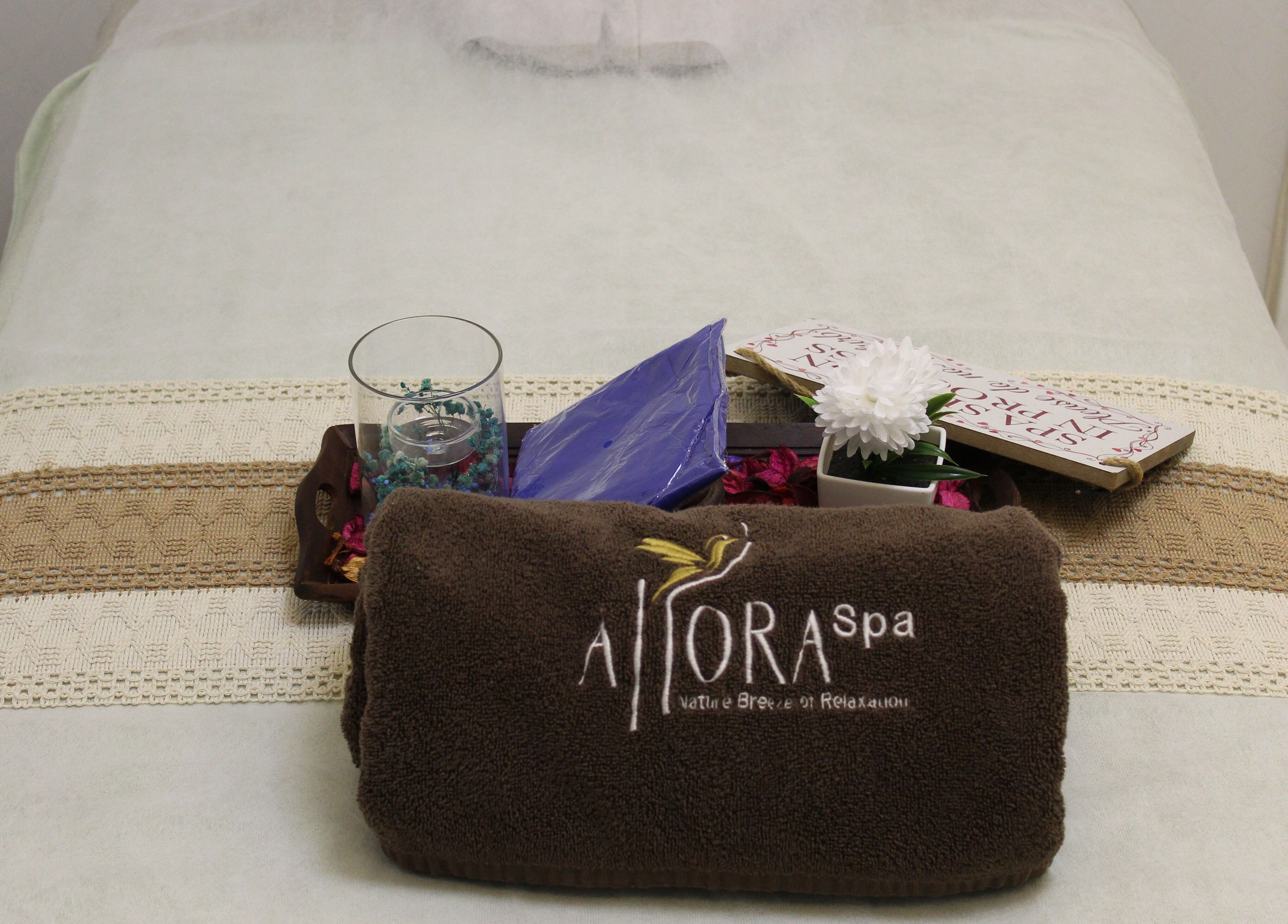 Massage bed at Allora Spa and Massage Centre Dubai, featuring plush towel and elegant decor, Dubai, Dubai, AE.