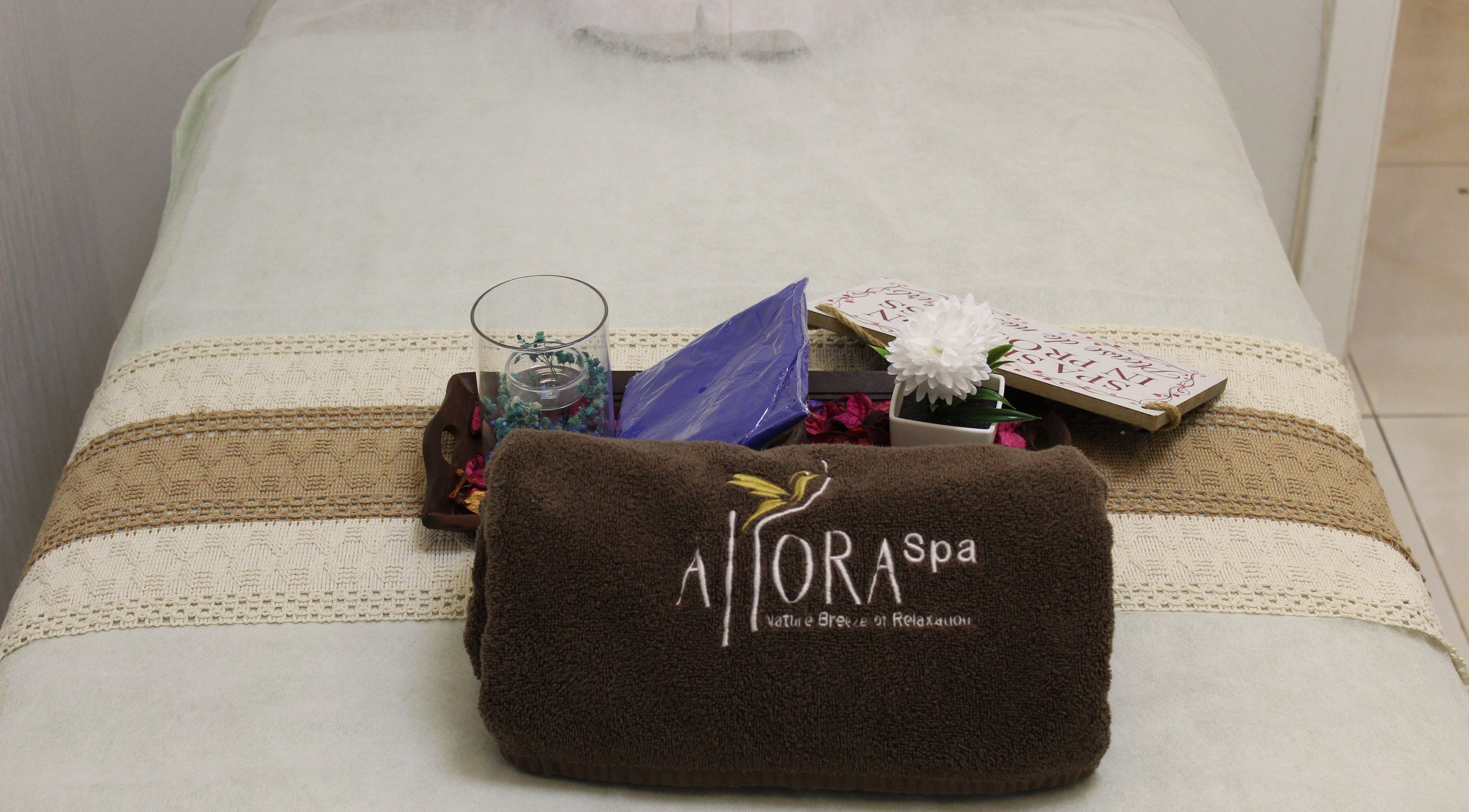 Massage bed at Allora Spa and Massage Centre Dubai, featuring plush towel and elegant decor, Dubai, Dubai, AE.