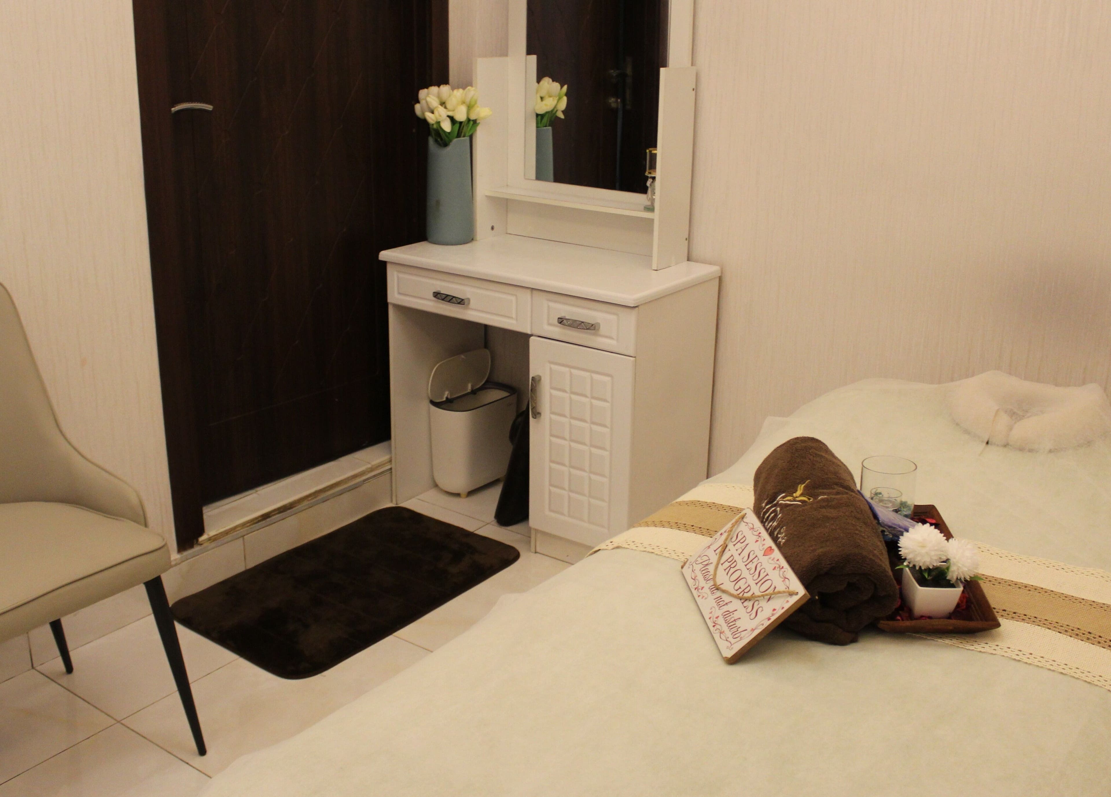 Serene spa room at Allora Spa and Massage Centre Dubai, showcasing a cozy massage table. Dubai, Dubai, AE.