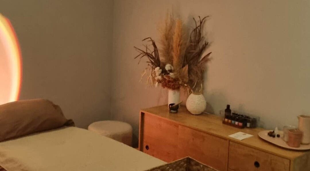 Tranquil massage room at Balancing Her, Helensvale, Queensland, AU with ambient lighting and natural decor.