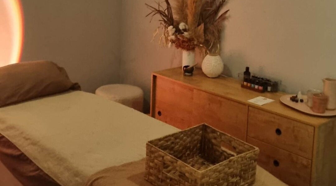 Calm therapy room at Balancing Her, Helensvale, Queensland, AU with massage bed and soothing decor.