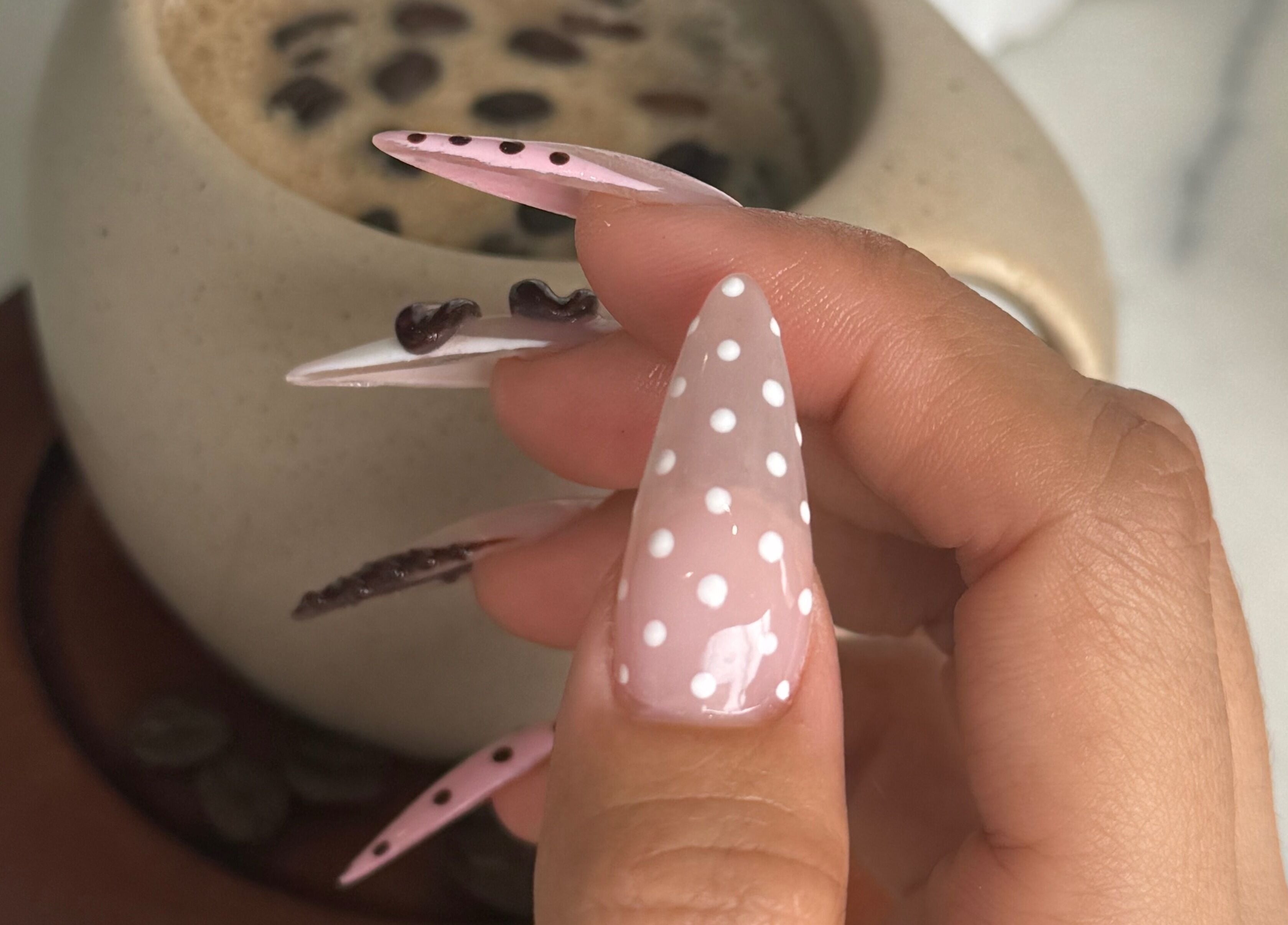 Stylish polka dot nails at Meow Nails Mawson Lakes, Mawson Lakes, South Australia, AU, with a coffee backdrop.