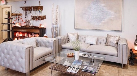 Elegant lounge area at Praha Spa and Salt in Naples, Florida, US with plush sofas and ambient decor.