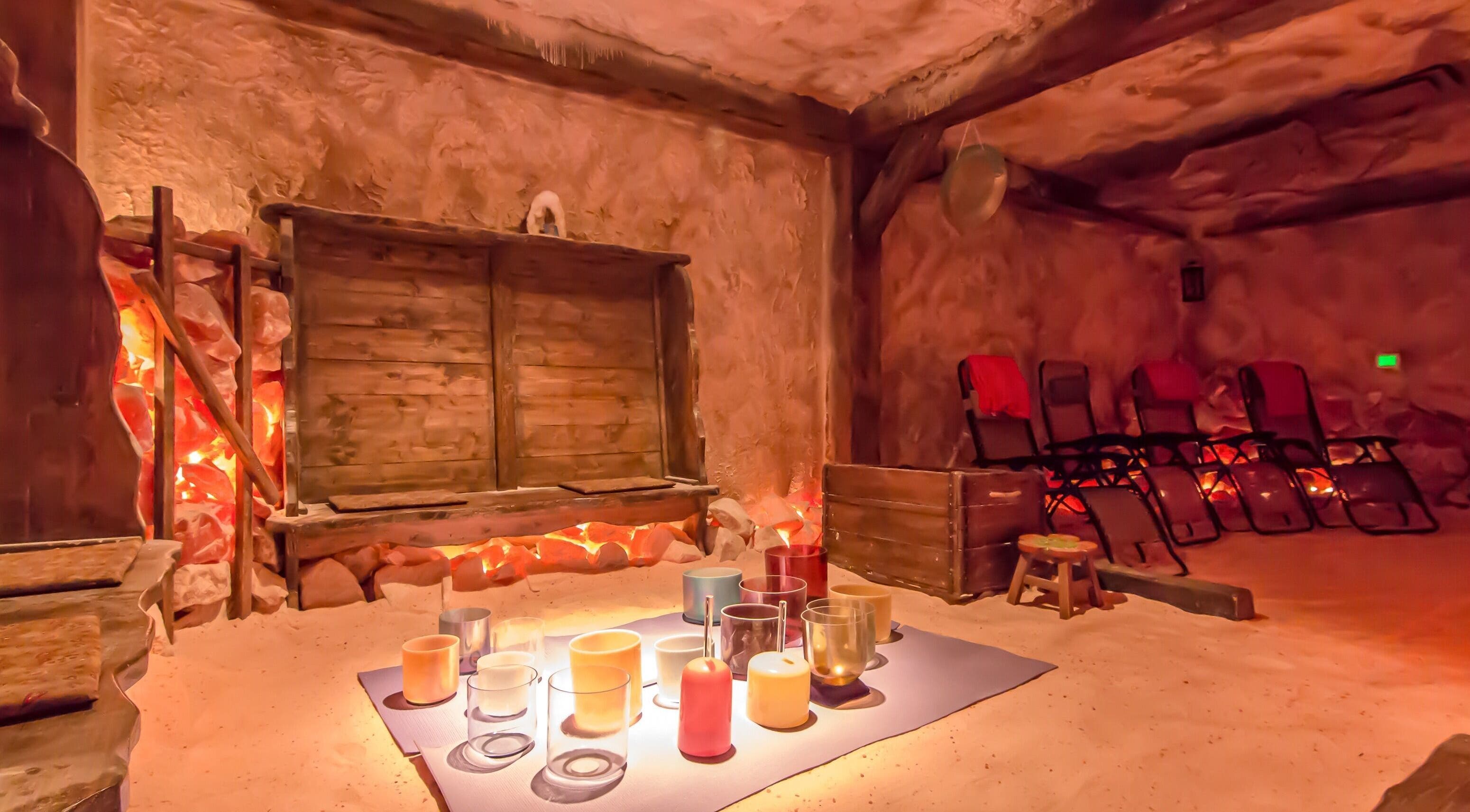 Cozy salt room at Praha Spa and Salt, Naples, Florida, US with warm lighting and relaxation chairs.