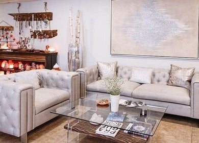 Elegant seating area at Praha Spa and Salt, Naples, Florida, US, with plush sofas and calming decor.