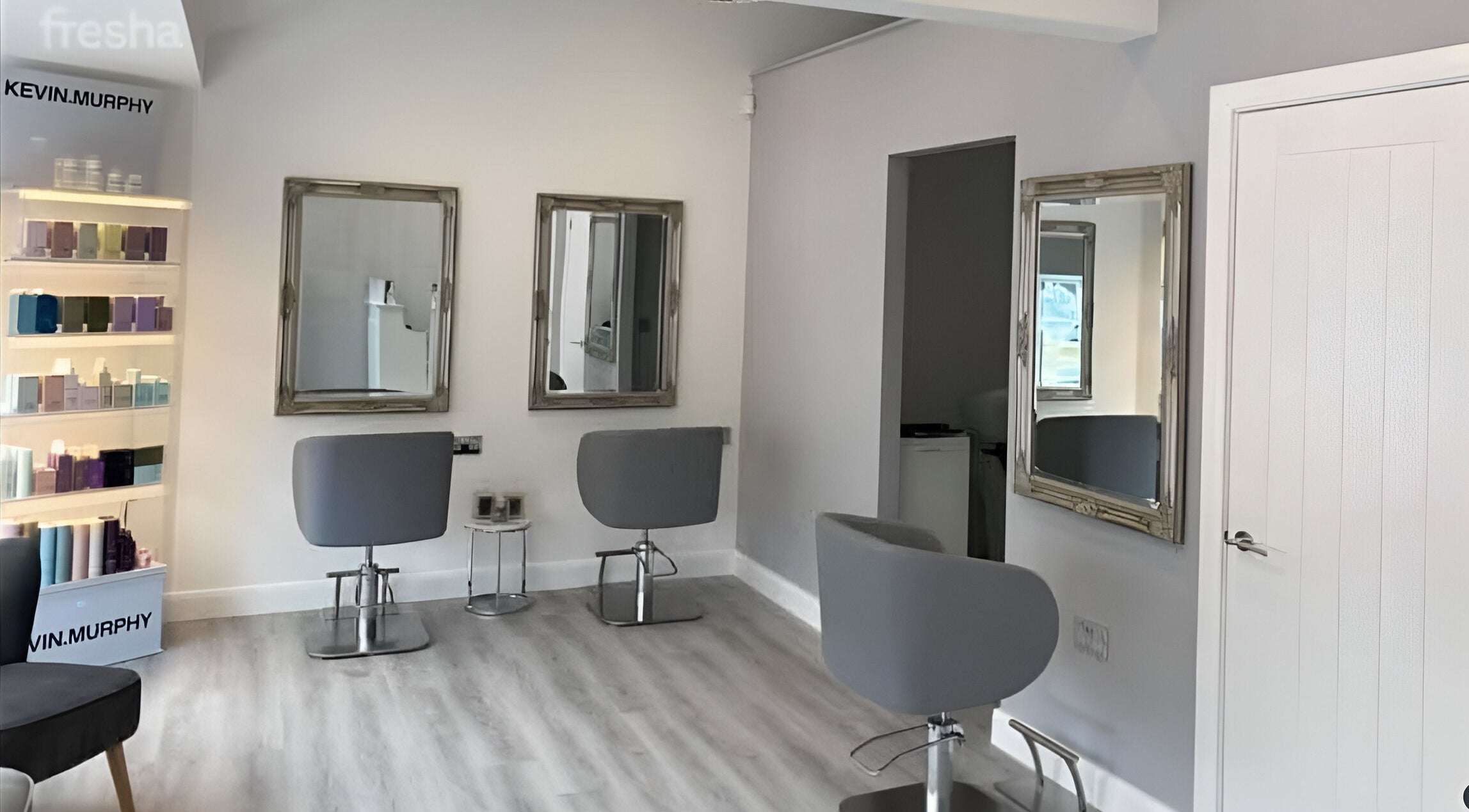Sleek salon interior of Jessica Laura Hairdressing in Calverley, England, GB featuring modern styling chairs and mirrors.