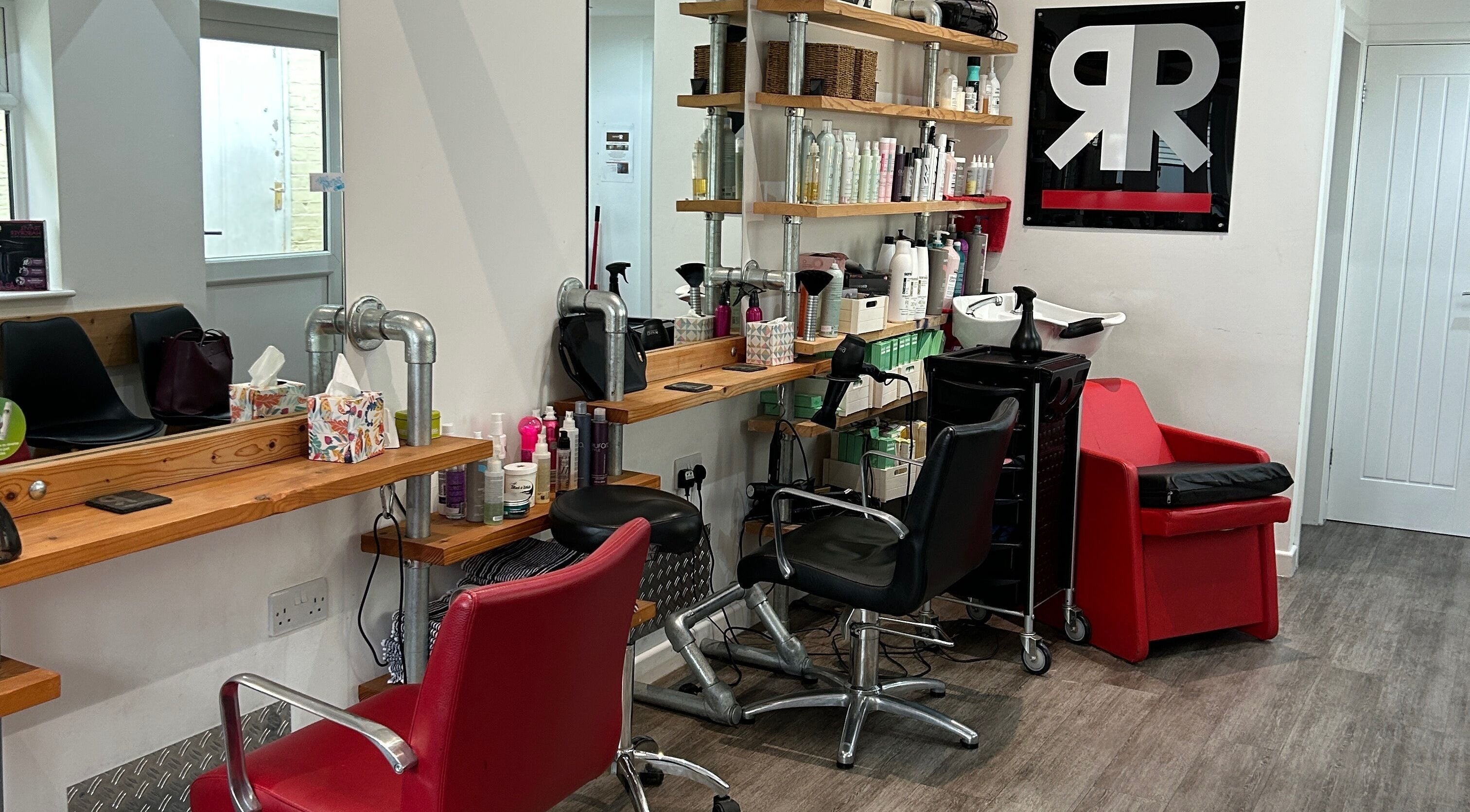 Modern hair studio at Julie at Reflections Hair Studio, Herstmonceux, England, GB with styling stations and products.