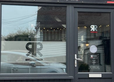 Front view of Julie at Reflections Hair Studio in Herstmonceux, England, GB with modern glass doors.