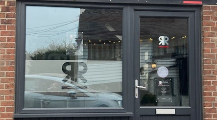 Front view of Julie at Reflections Hair Studio in Herstmonceux, England, GB with modern glass doors.