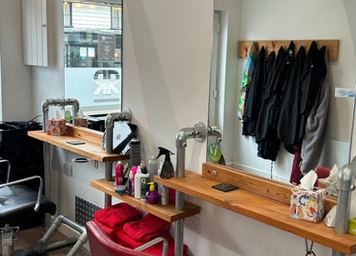 Charming salon station at Julie at Reflections Hair Studio, Herstmonceux, England, GB, featuring modern decor.