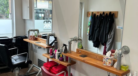 Charming salon station at Julie at Reflections Hair Studio, Herstmonceux, England, GB, featuring modern decor.