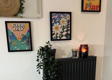 Bright artwork and candles at The BeautyVix at Salon V in Leigh, England, GB creating a welcoming vibe.