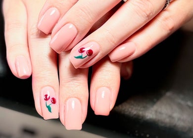 Elegant nude nails with cherry design at The BeautyVix at Salon V, Leigh, England, GB.