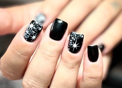 Black nails with star design at The BeautyVix at Salon V, Leigh, England, GB.