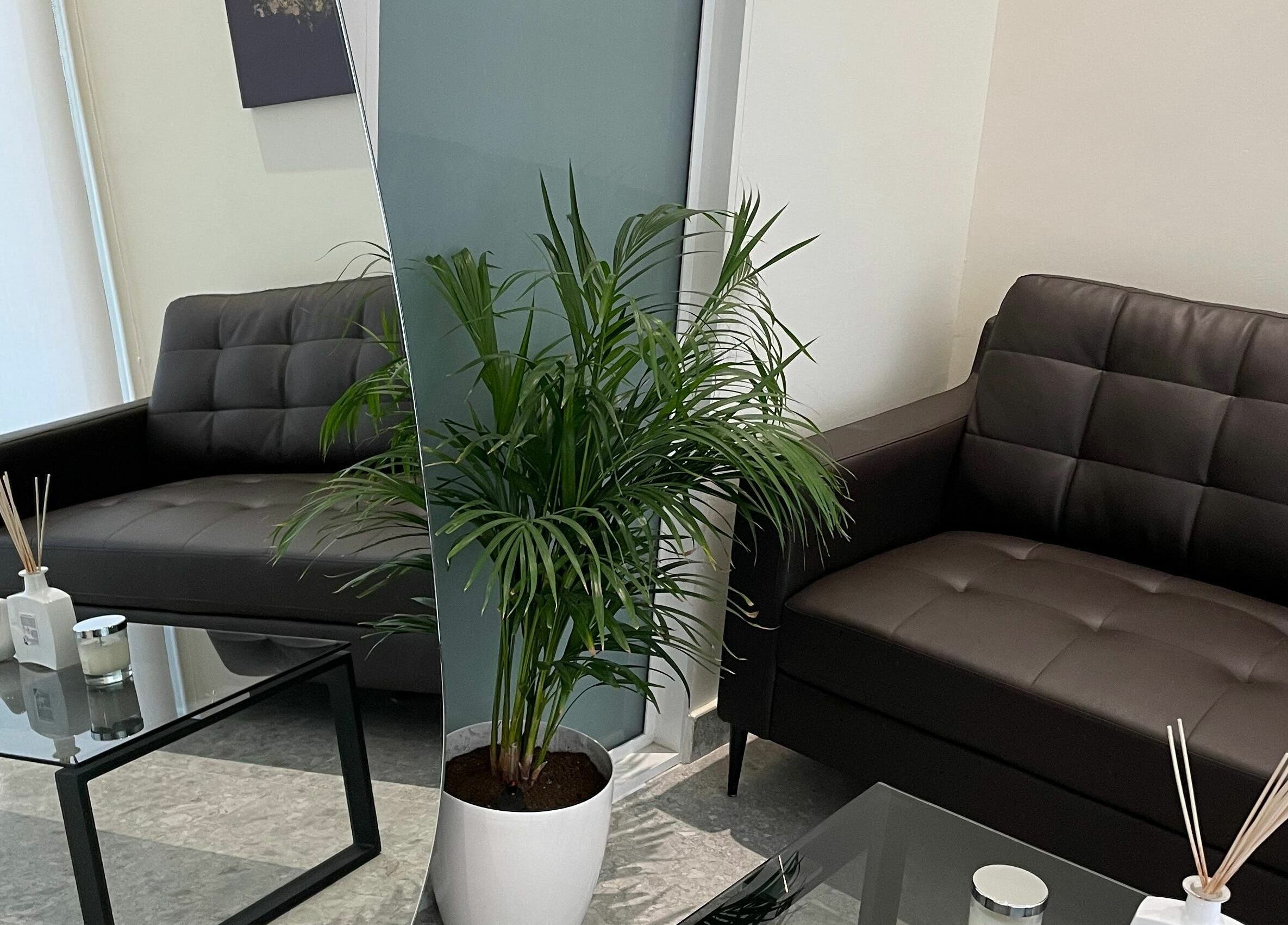 Cozy seating area at Naya Spa, Riyadh, Riyadh Province, SA with chic sofas and greenery.