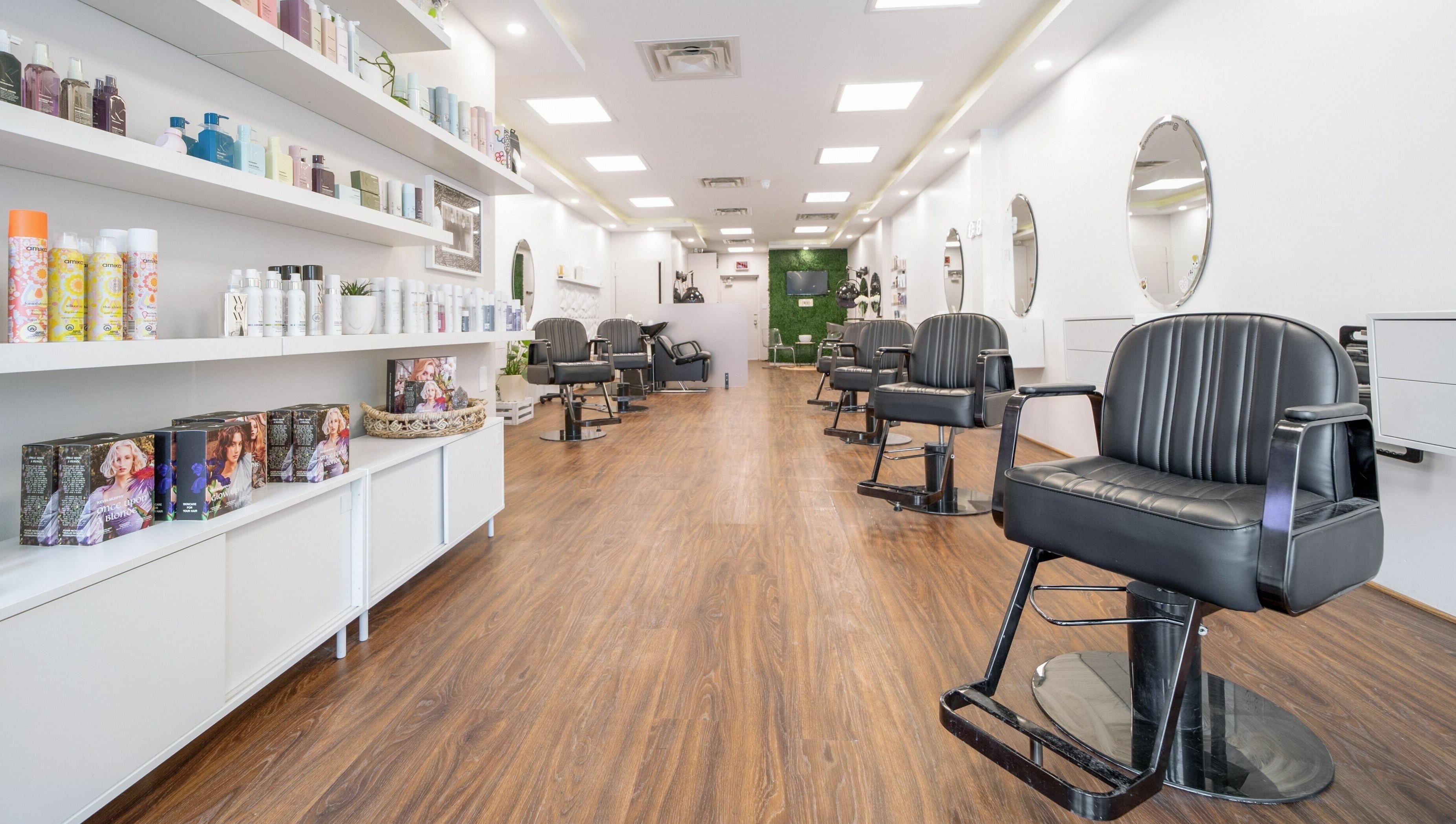 Modern interior of Twin Scissors salon in Toronto, Ontario, CA featuring sleek chairs and stylish decor.