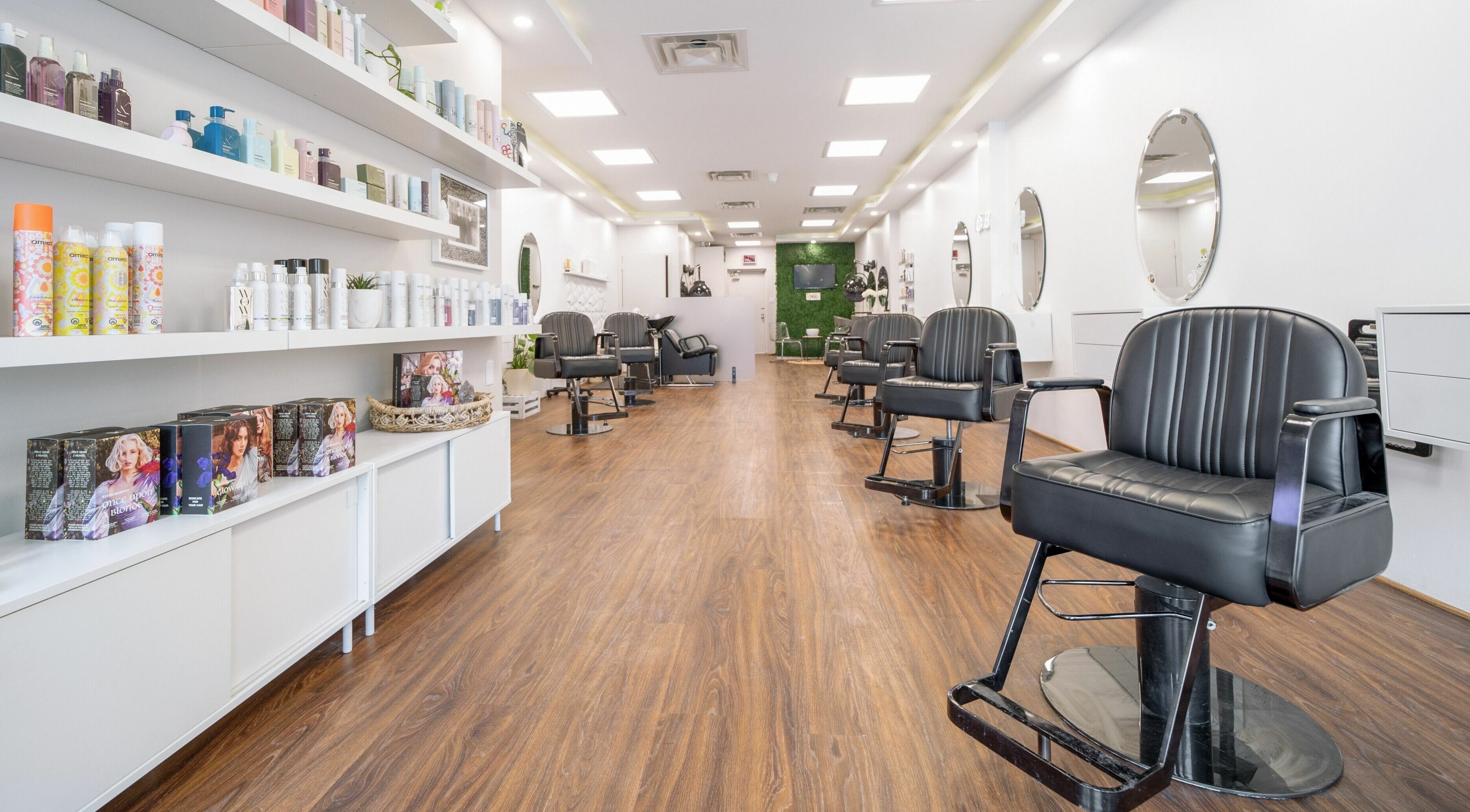 Modern interior of Twin Scissors salon in Toronto, Ontario, CA featuring sleek chairs and stylish decor.