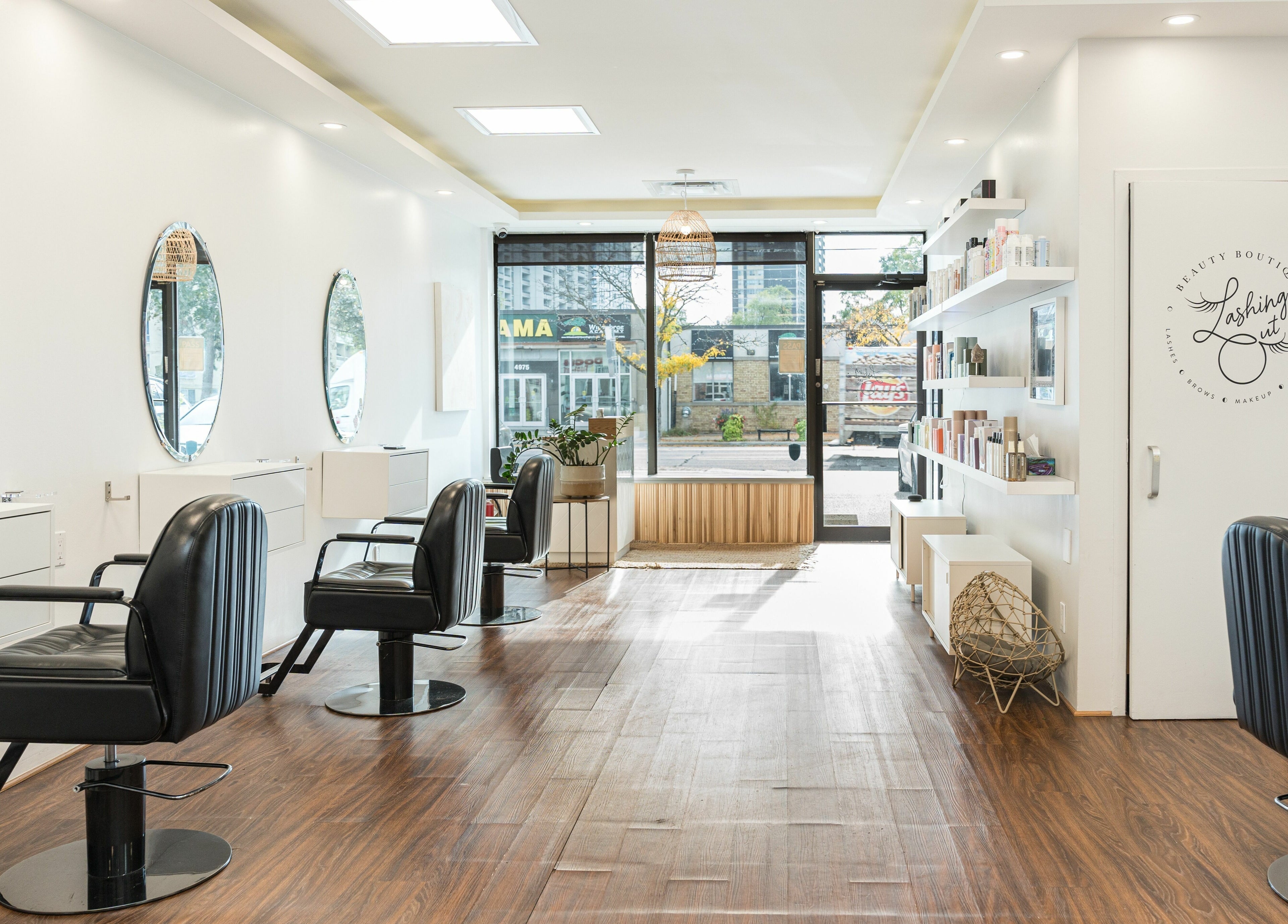Chic interior of Twin Scissors salon in Toronto, Ontario, CA with stylish chairs and mirrors.