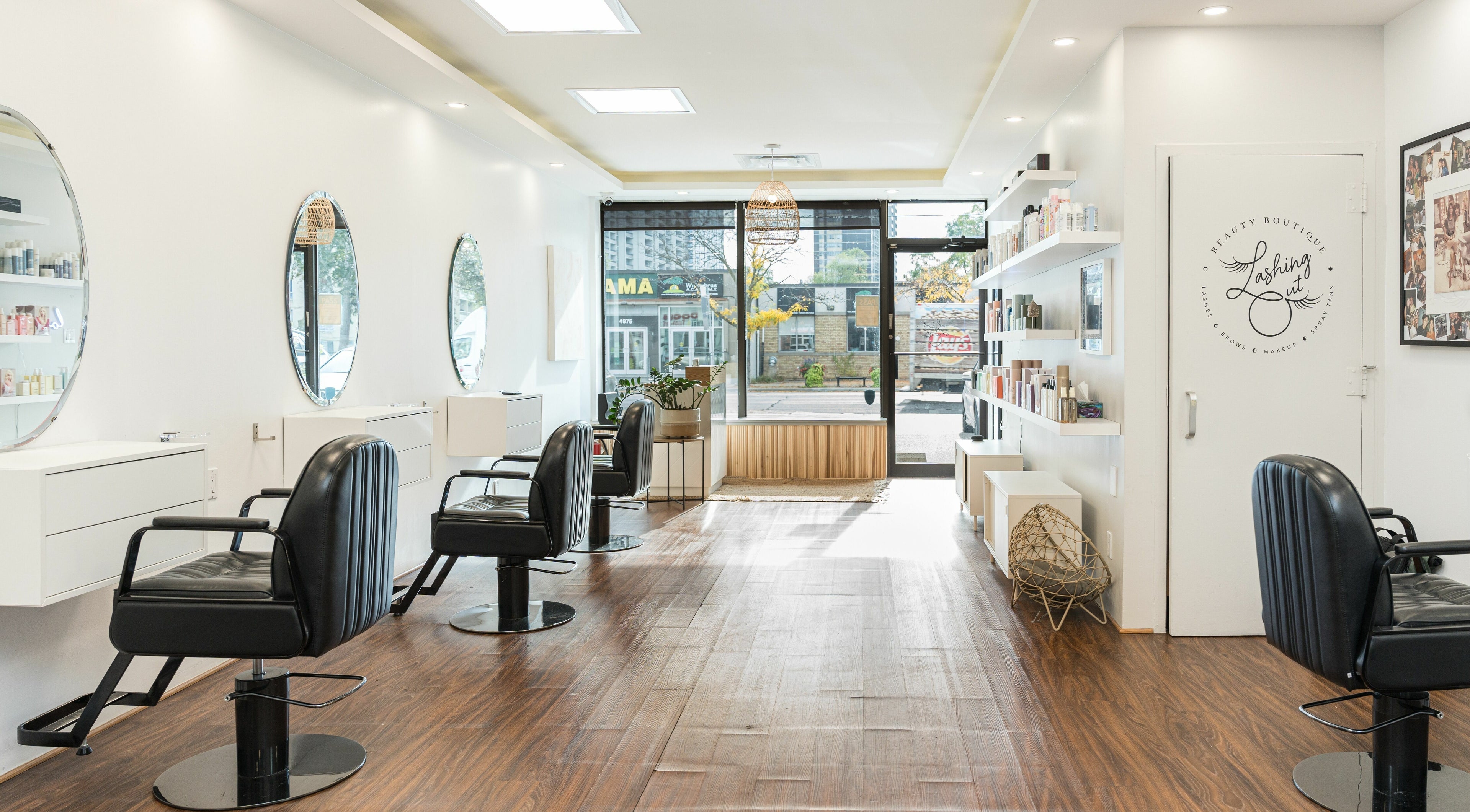Chic interior of Twin Scissors salon in Toronto, Ontario, CA with stylish chairs and mirrors.