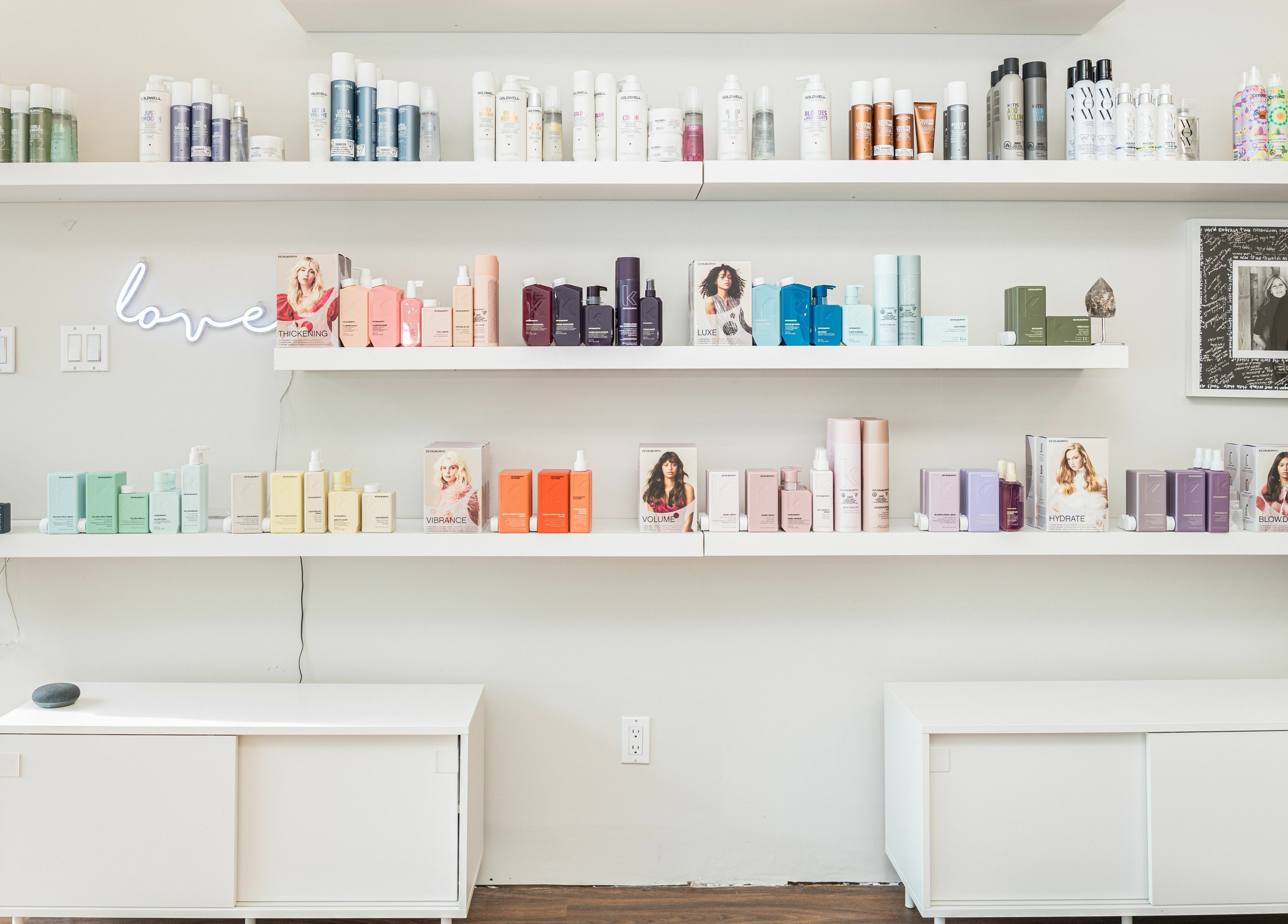 Shelves with beauty products at Twin Scissors, Toronto, Ontario, CA displaying a variety of hair care brands.