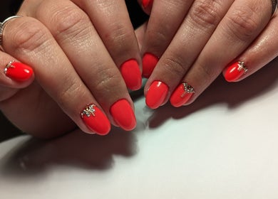 Vibrant red manicured nails with gem accents at Marta's Beauty Lounge, Burton Upon Trent, England, GB.