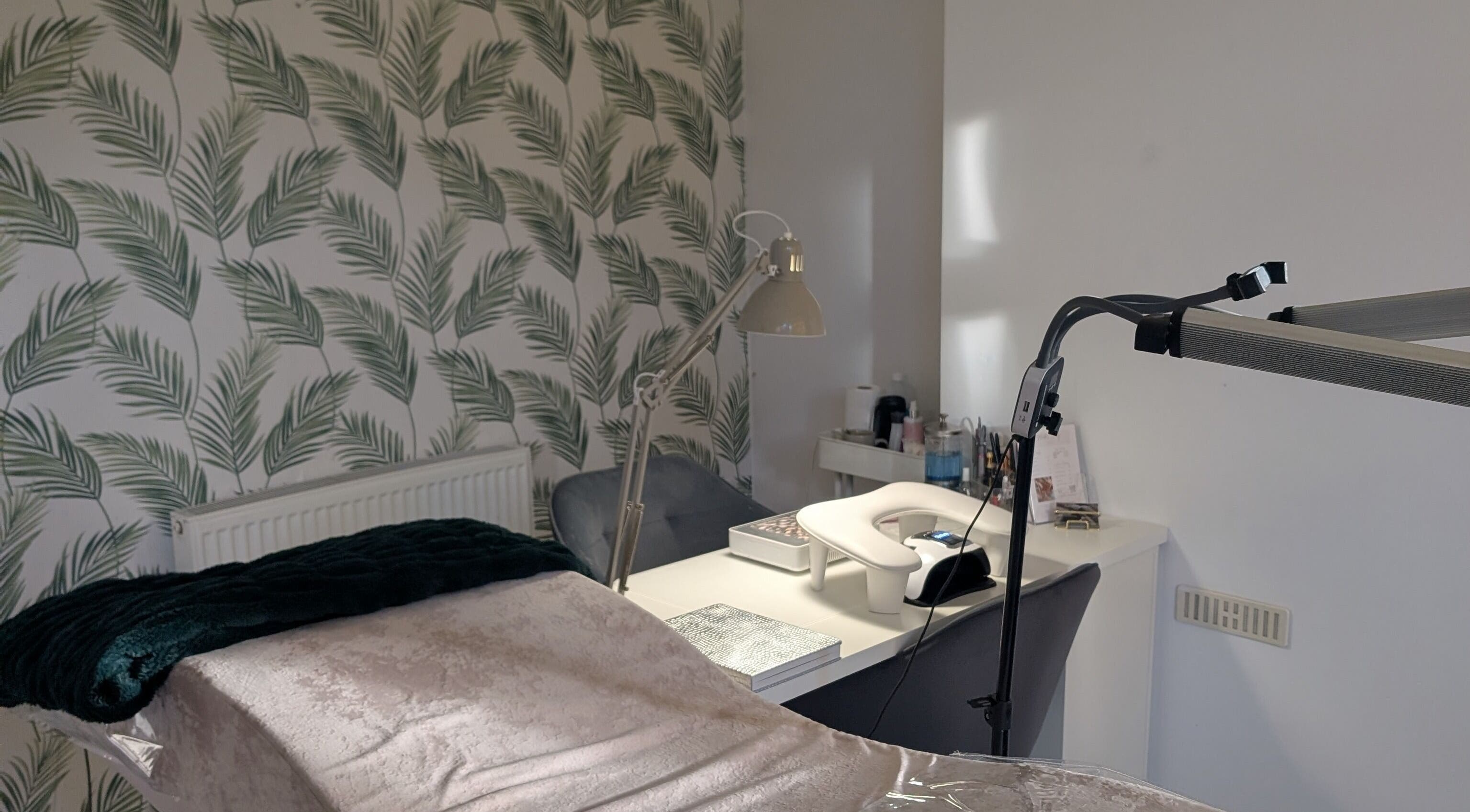 Tranquil treatment room at Marta's Beauty Lounge, Burton Upon Trent, England, GB with palm leaf decor.