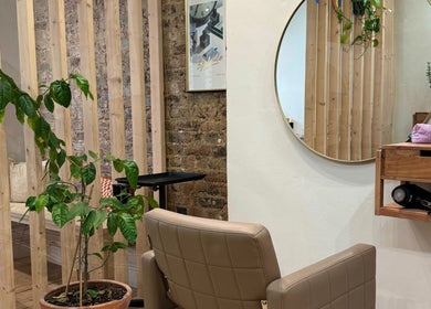Chic interior at AmeliaJHair salon, Brighton And Hove, England, GB, showcasing stylish seating and decor.