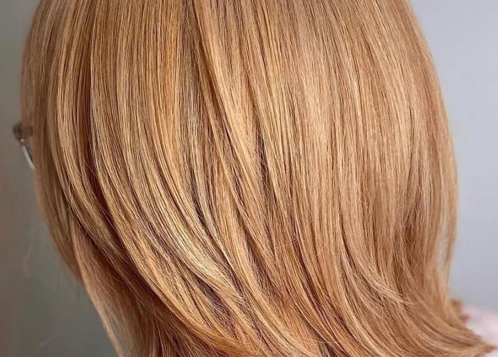 Golden layered hairstyle at AmeliaJHair, Brighton And Hove, England, GB. Sleek and stylish haircut.