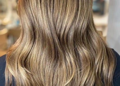 Glossy, wavy golden hair styled at AmeliaJHair in Brighton And Hove, England, GB, showcasing a luminous finish.