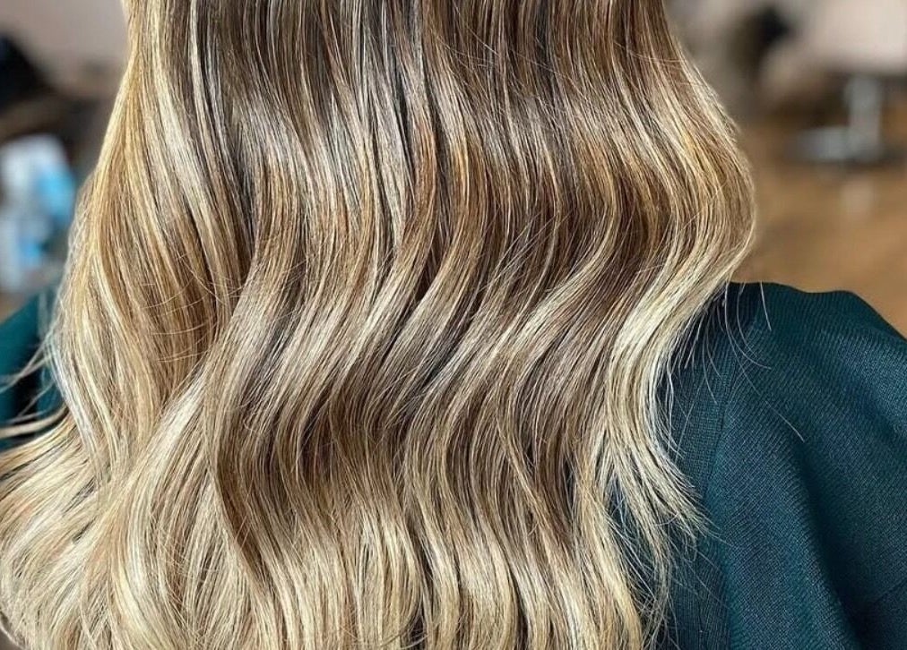 Elegant wavy blonde hair styled at AmeliaJHair in Brighton And Hove, England, GB.