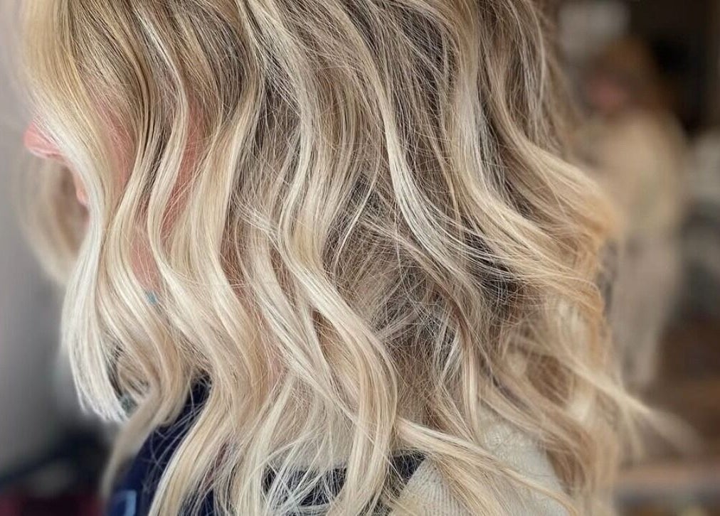 Elegant wavy blonde hair styled at AmeliaJHair in Brighton And Hove, England, GB, showcasing expert hair techniques.