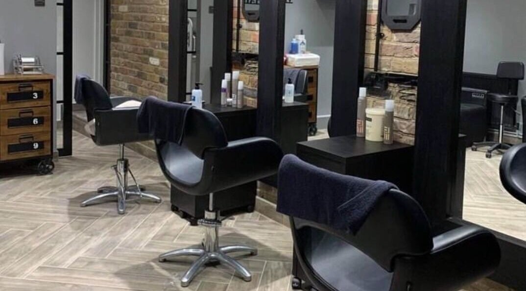 Modern salon chairs and styling stations at Venus Hair in Woking, England, GB.
