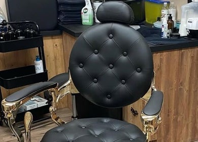 Elegant barber chair at 10/6 Barber Company, Belleville, Ontario, CA, showcasing a stylish interior.